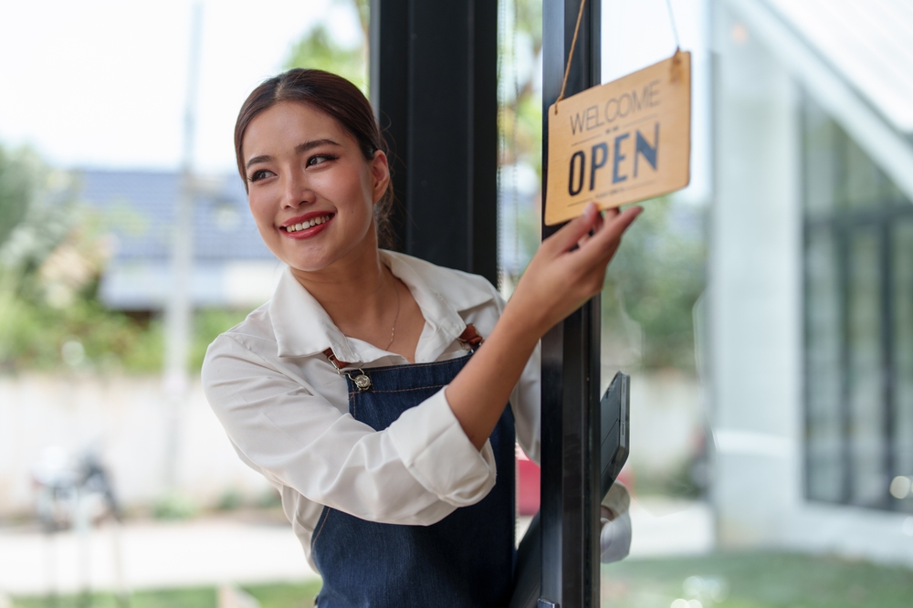 A food business team member welcoming customers